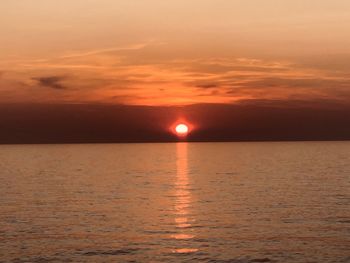 Scenic view of sea against romantic sky at sunset