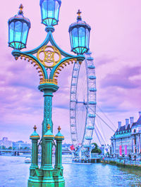 Illuminated street light against blue sky