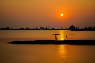 Scenic view of sea against orange sky