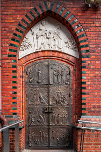 View of ornate door on brick wall