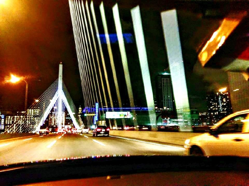 ILLUMINATED SUSPENSION BRIDGE AGAINST SKY AT NIGHT