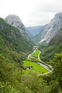 Scenic view of valley and mountains against sky