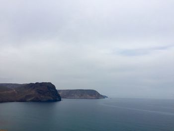 View of calm sea against cloudy sky
