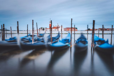 Boats moored in sea against sky