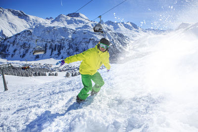 Young man skiing on snowcapped mountains during winter