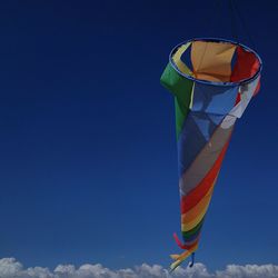 Low angle view of flag against clear blue sky