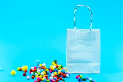 Close-up of multi colored candies against blue background