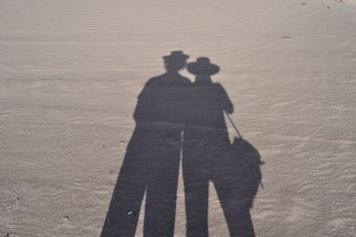 Shadow of man on sand at beach