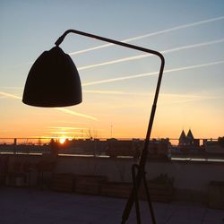 Silhouette of city against sky during sunset