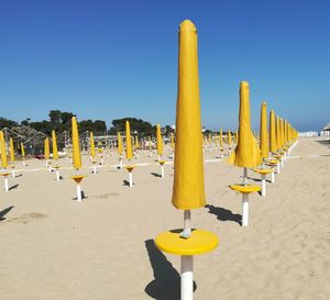 Closed beach umbrellas in a row