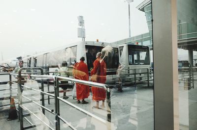 People walking on bridge in city