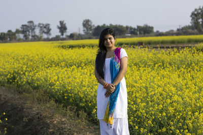 Young woman standing on field