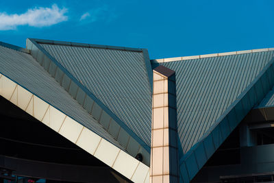 Low angle view of modern building against blue sky