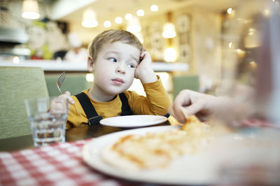 Woman eating food in restaurant