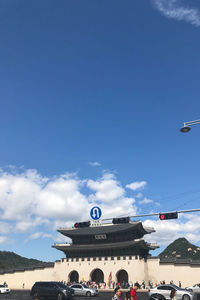 People on airplane against blue sky