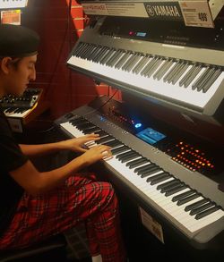 Low angle view of man playing piano