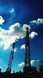 Low angle view of crane against sky