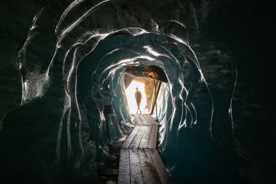 Person standing in cave