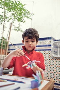 Children playing in an inner courtyard and painting with water paints