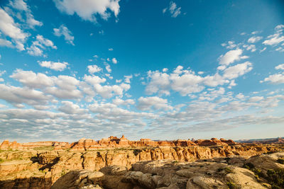 Blue skies and puffy white clouds over the canyons of the maze utah