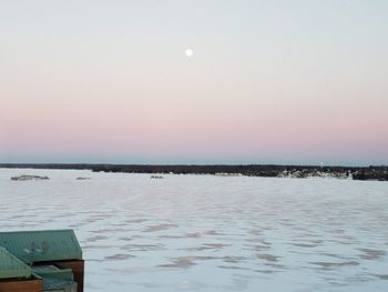 Scenic view of sea against clear sky at dusk