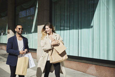 Friends walking down street with shopping bags