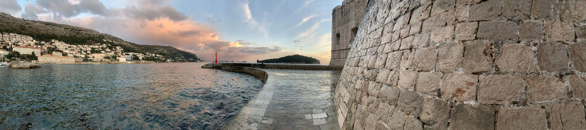 Panoramic shot of wall by sea against sky