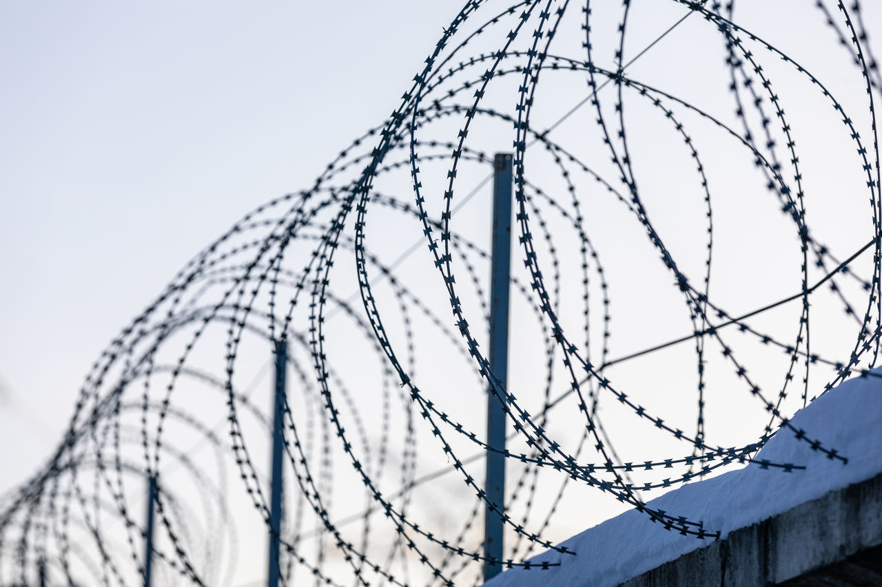 LOW ANGLE VIEW OF FENCE AGAINST SKY