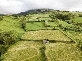 High angle view of green landscape against sky