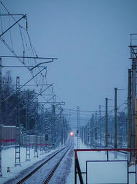 Railroad tracks against sky during winter