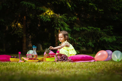 Cute girl having fruits in park