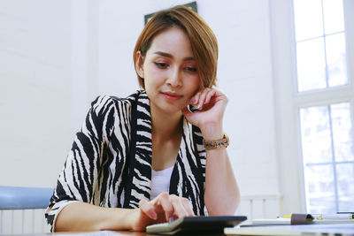 Portrait of young woman using mobile phone