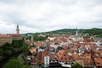 Buildings in town against cloudy sky