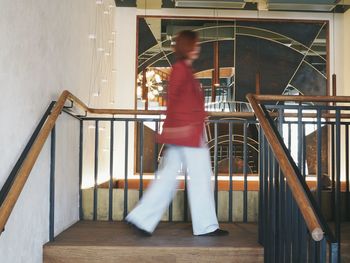 Side view of man walking on staircase in building