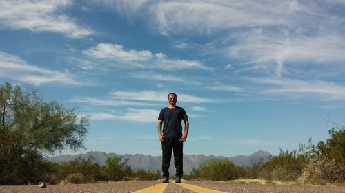 Full length of man standing on road against sky