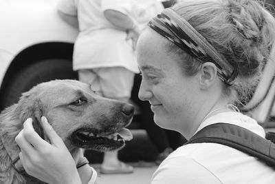 Close-up of woman stroking dog