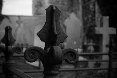 Close-up of rusty metal fence in cemetery