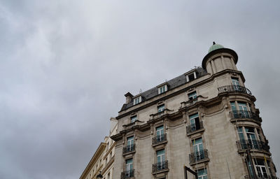 Low angle view of building against cloudy sky