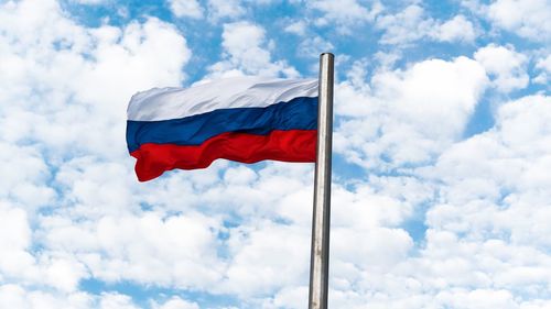 Low angle view of flag against sky