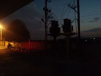 View of illuminated street lights at night