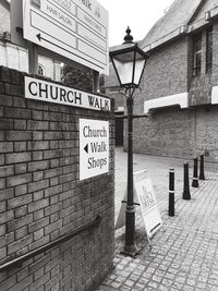 Road sign against brick wall