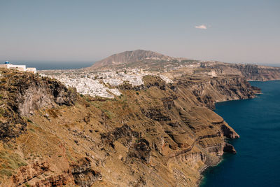 Scenic view of sea and mountains against clear sky