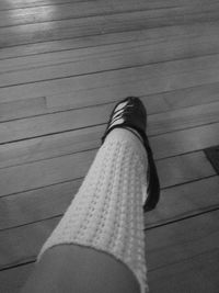 Low section of woman standing on wooden plank