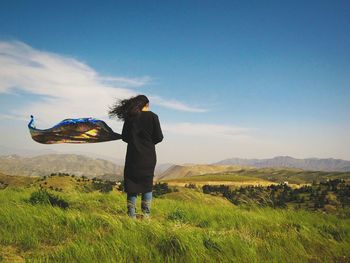 People standing on grassy field