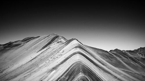 Low angle view of mountain range against clear sky