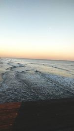 Scenic view of sea against clear sky during sunset