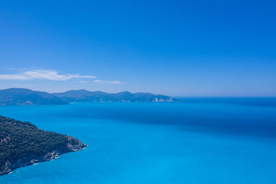 Scenic view of sea against clear blue sky