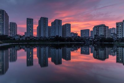 Reflection of buildings in river at sunset
