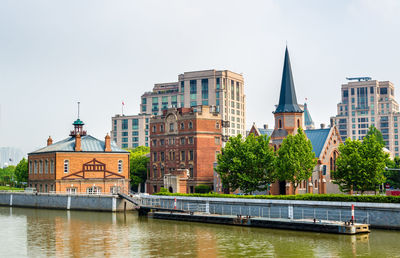 River amidst buildings against sky in city