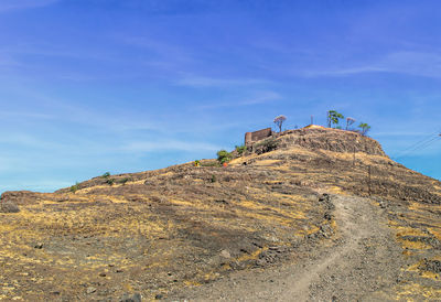 Low angle view of mountain against blue sky